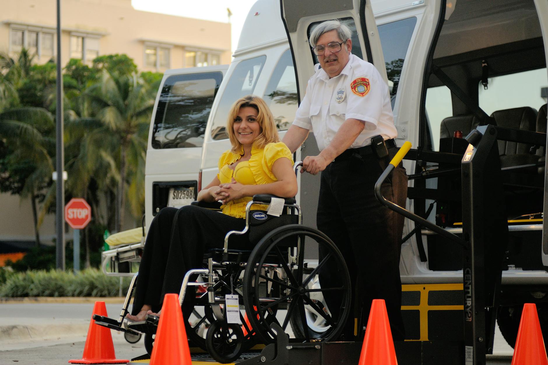 A transport service assisting a person in a wheelchair outdoors, focusing on accessibility. (Photo by DΛVΞ GΛRCIΛ on Pexels)