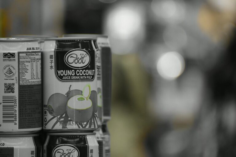 A stack of young coconut juice cans on a shelf with a retail background. (Photo by Karthick Manoharan on Pexels)