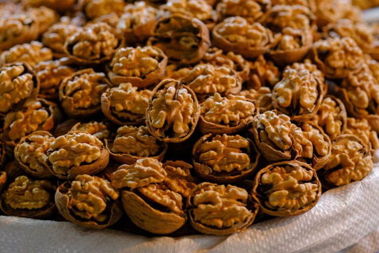 A detailed close-up photo showcasing a pile of fresh organic walnuts in shells, perfect for healt... (Photo by Engin Akyurt on Pexels)