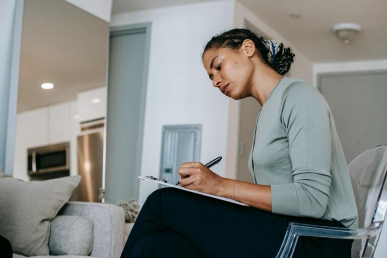 Side view focused ethnic female psychotherapist or HR interviewer writing notes in clipboard whil... (Photo by Alex Green on Pexels)